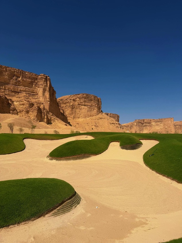 Bunkers and fairway at the Qiddiya golf course beneath the Tuwaiq cliffs