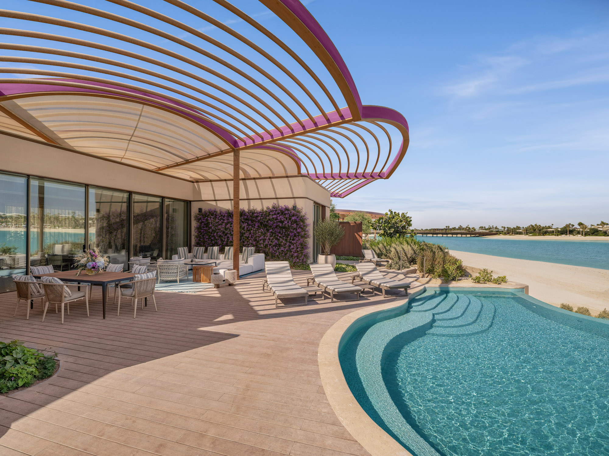 Pool terrace under a curved pergola at Raffles The Red Sea on Shura Island, facing the lagoon and beach