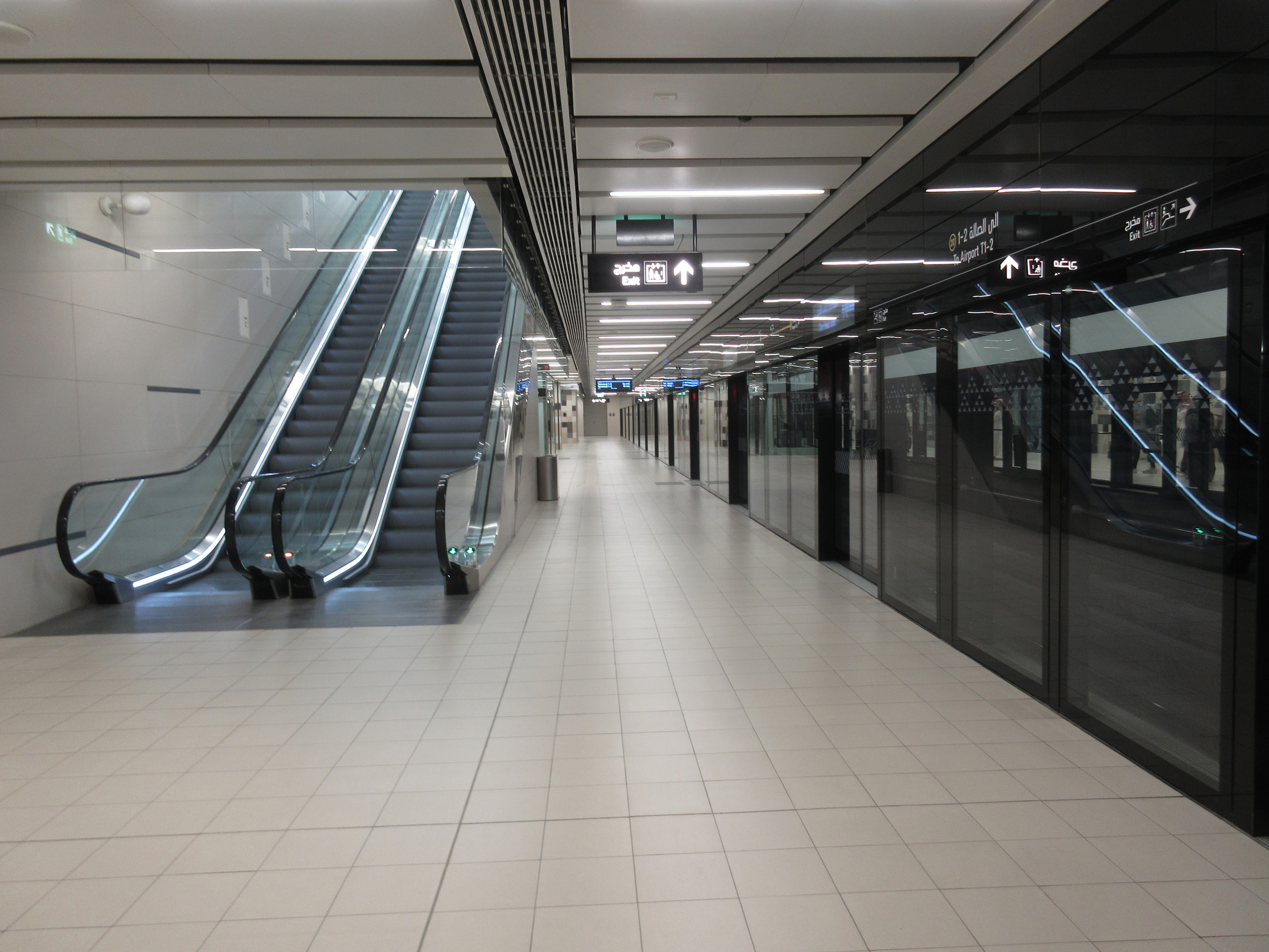 Underground platform with platform screen doors at a Riyadh Metro airport station, an existing line shown for illustration
