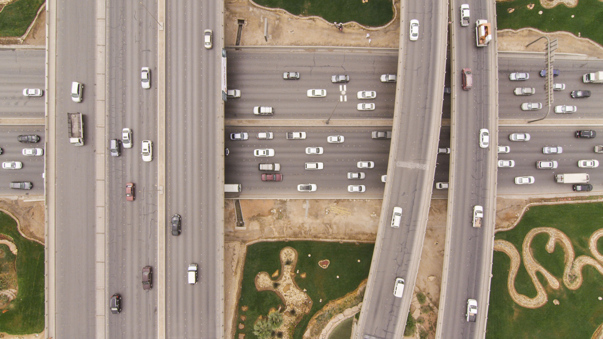 Aerial view of a highway interchange in Riyadh with flyovers crossing a multi-lane road