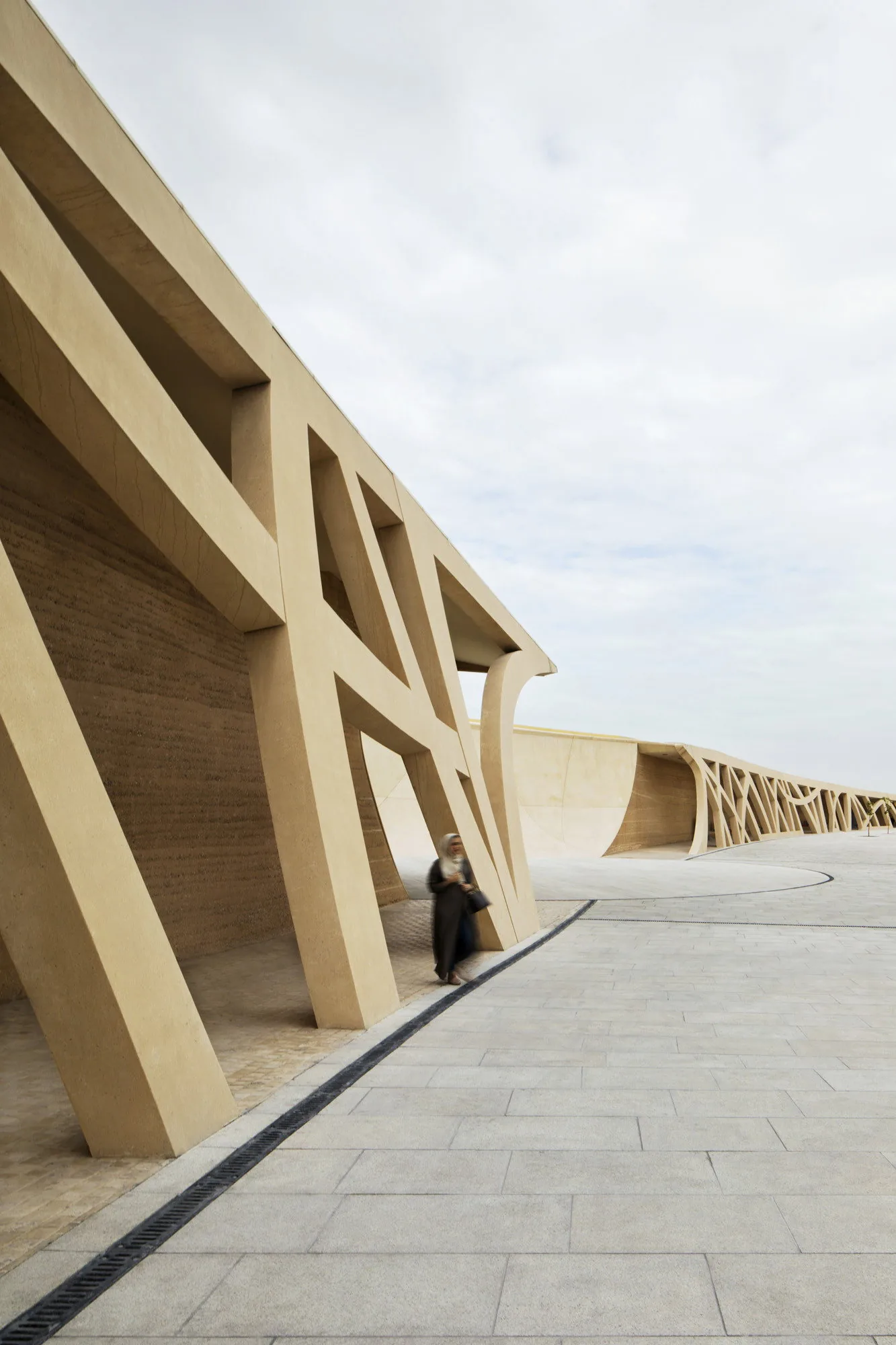 Rammed earth walls framing the plaza