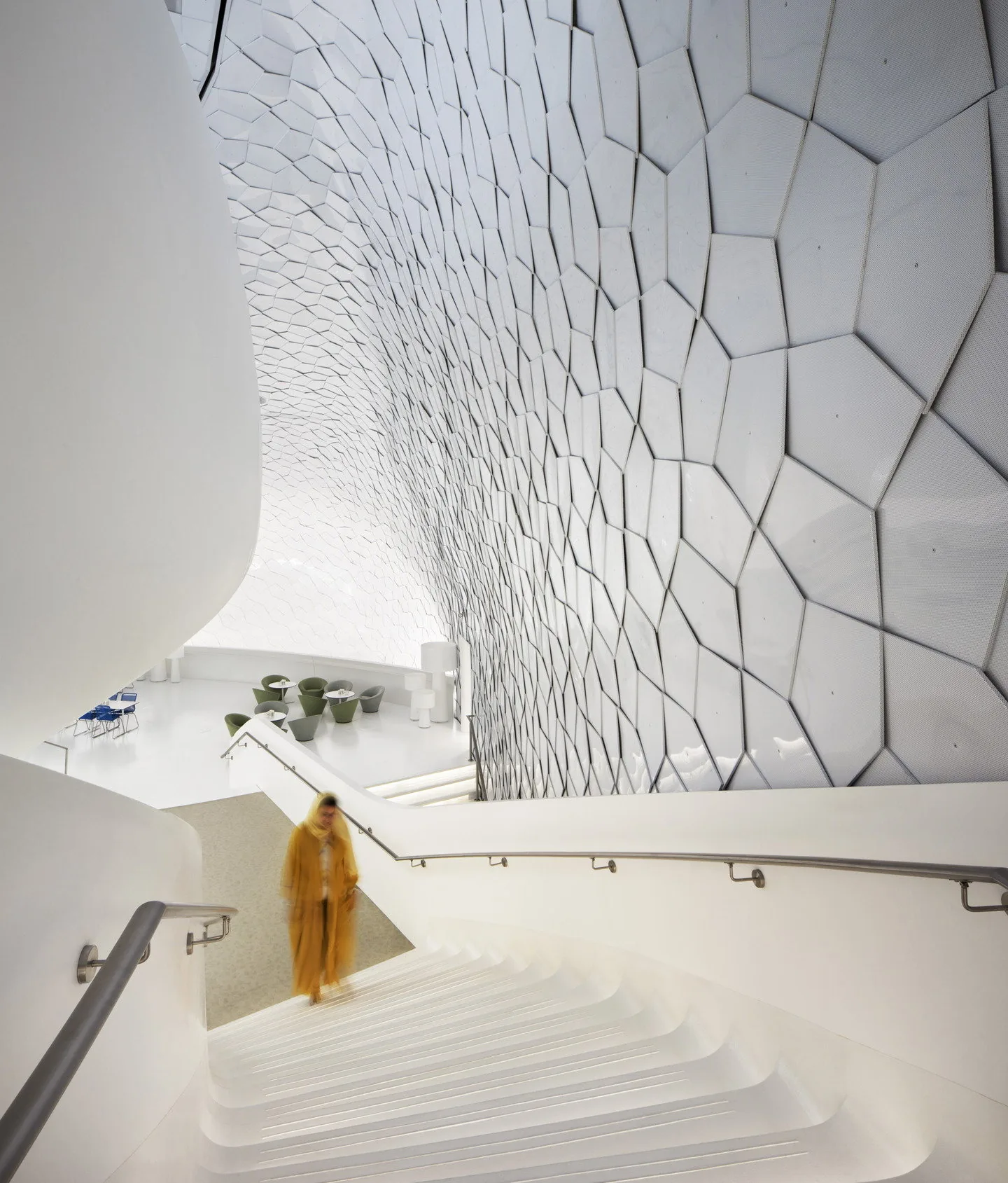 An interior stair beneath a faceted wall
